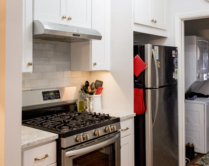 white cupboards with gas stove